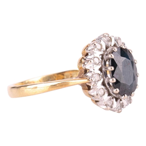 122 - A sapphire and diamond cluster ring in 18ct gold, comprising an oval-cut sapphire of dark blue colou... 