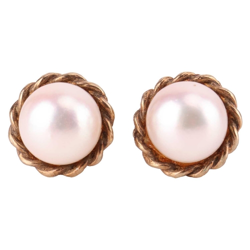 14 - A pair of cultured pearl stud earrings in 9ct gold mounts, together with a cultured pearl solitaire ... 