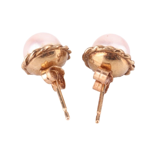 14 - A pair of cultured pearl stud earrings in 9ct gold mounts, together with a cultured pearl solitaire ... 