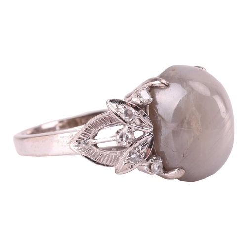 28 - A grey star sapphire and diamond dress ring, featuring an oval cabochon of a light grey sapphire cab... 