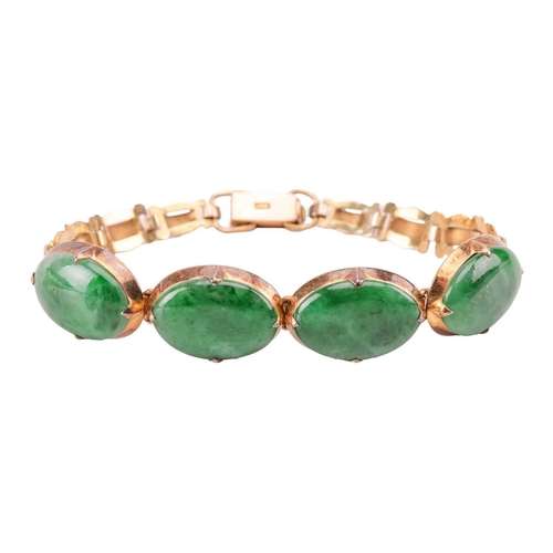 29 - A jade link bracelet, comprising four oval jadeite cabochons in of dark green colour, approximately ... 