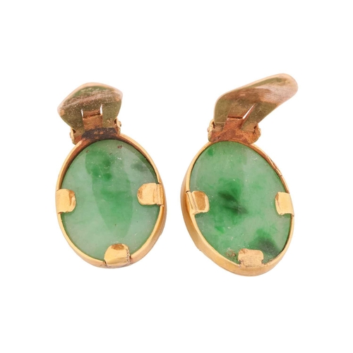 31 - A pair of jade clip-on earrings or dress clips; each containing an oval jadeite cabochon with a mott... 