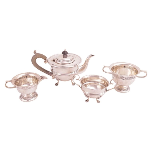 330 - A bachelor teapot and matching sugar basin; circular with a reeded band to the girdle, on four shell... 