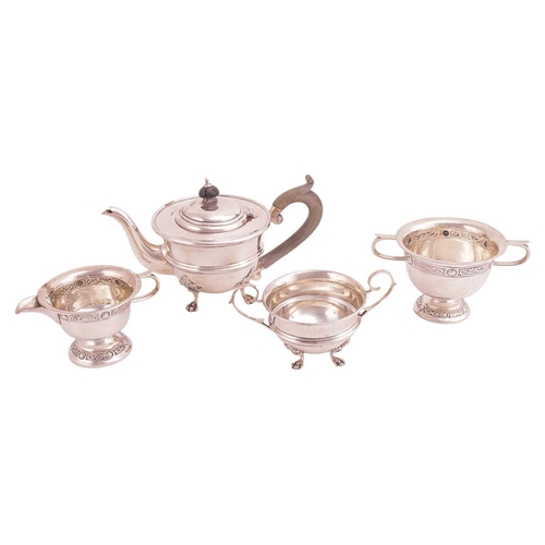 330 - A bachelor teapot and matching sugar basin; circular with a reeded band to the girdle, on four shell... 