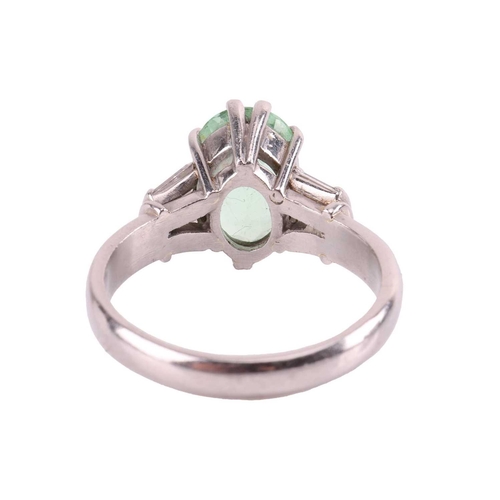 37 - A tourmaline and diamond dress ring, centred with a pale apple green oval-cut tourmaline of 10.7 x 7... 