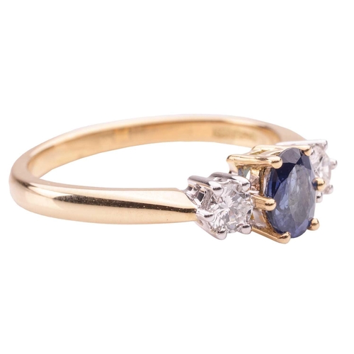 39 - A sapphire and diamond trilogy ring in 18ct yellow gold, centred with an oval-cut sapphire of 6.1 x ... 