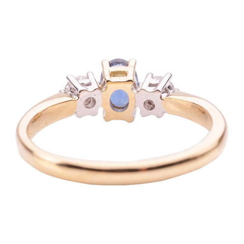 39 - A sapphire and diamond trilogy ring in 18ct yellow gold, centred with an oval-cut sapphire of 6.1 x ... 