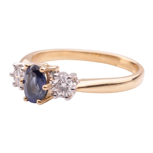 39 - A sapphire and diamond trilogy ring in 18ct yellow gold, centred with an oval-cut sapphire of 6.1 x ... 