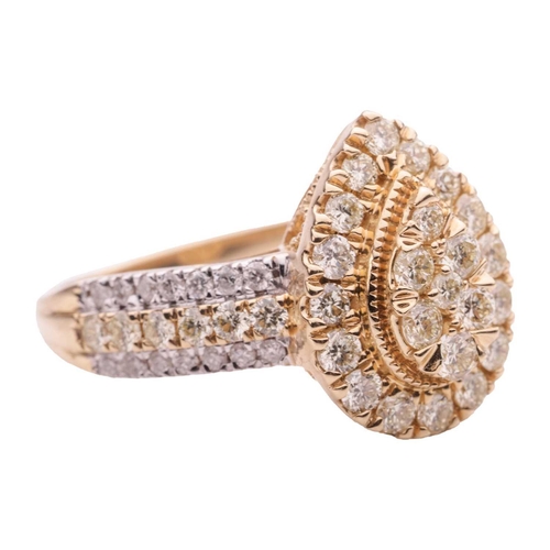 50 - A diamond cluster ring in 14ct gold, the tiered pear-shaped head pavé-set with yellow-tinted brillia... 