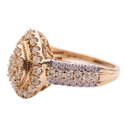 50 - A diamond cluster ring in 14ct gold, the tiered pear-shaped head pavé-set with yellow-tinted brillia... 