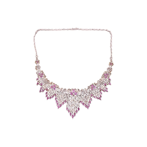 60 - A pink sapphire and diamond parure comprising a necklace, a bracelet, a ring and a pair of pendant e... 