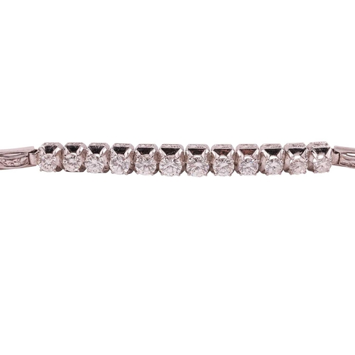 64 - A diamond-set bracelet, claw-set with twelve round brilliant diamonds, with an estimated total diamo... 