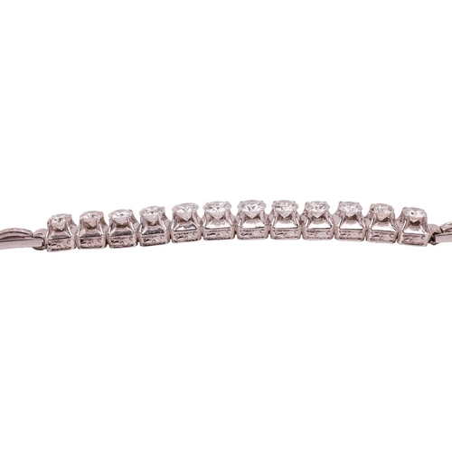 64 - A diamond-set bracelet, claw-set with twelve round brilliant diamonds, with an estimated total diamo... 