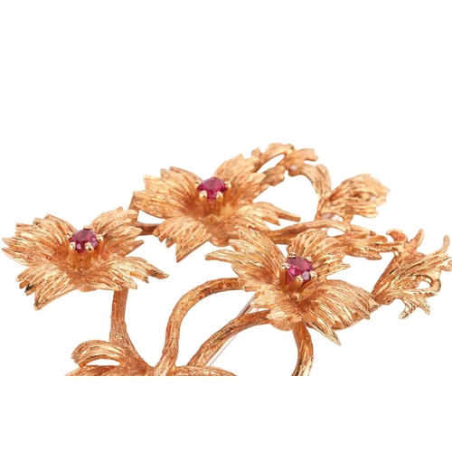 65 - A stylised spray brooch in 18ct gold by Cropp and Farr, textured flowerheads highlighted with circul... 