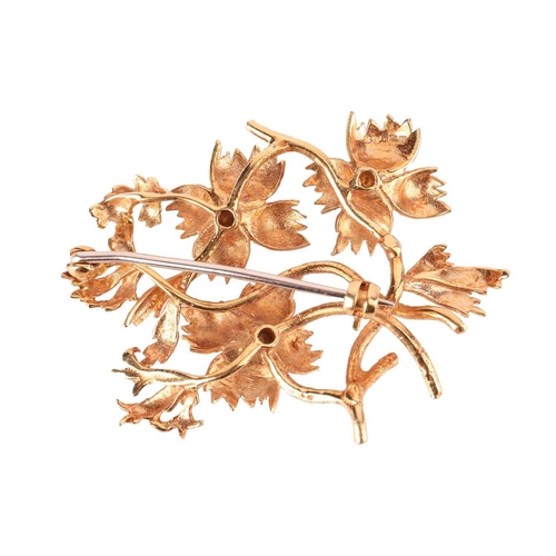 65 - A stylised spray brooch in 18ct gold by Cropp and Farr, textured flowerheads highlighted with circul... 