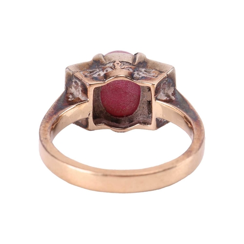 67 - A star ruby and diamond dress ring, centred with an oval star ruby of 8.3 x 6.5 x 5.8 mm, claw-set b... 