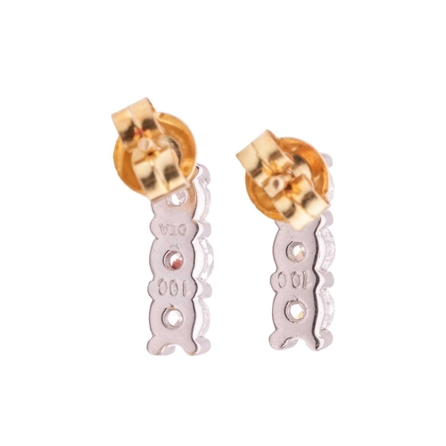 68 - A pair of diamond-set earrings in 18ct gold, each earring featuring three graduated round brilliant-... 