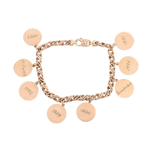 74 - A sentimental bracelet with disc charms, comprising a series of fancy figure of eight links, suspend... 