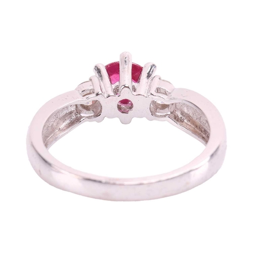 86 - A ruby cabochon and diamond dress ring, centred with an oval ruby cabochon of 5.9 x 5.0 x 2.8 mm, in... 