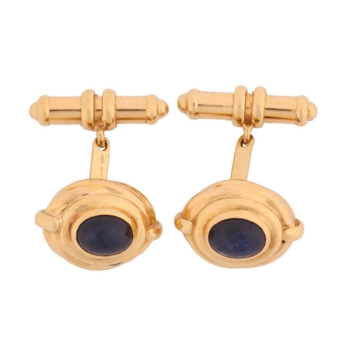 97 - A pair of sapphire-set cufflinks, of Hellenistic style, each contains an oval sapphire cabochon of 8... 