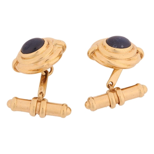 97 - A pair of sapphire-set cufflinks, of Hellenistic style, each contains an oval sapphire cabochon of 8... 