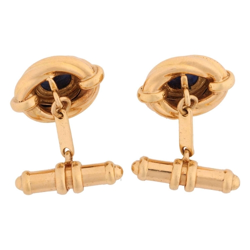 97 - A pair of sapphire-set cufflinks, of Hellenistic style, each contains an oval sapphire cabochon of 8... 