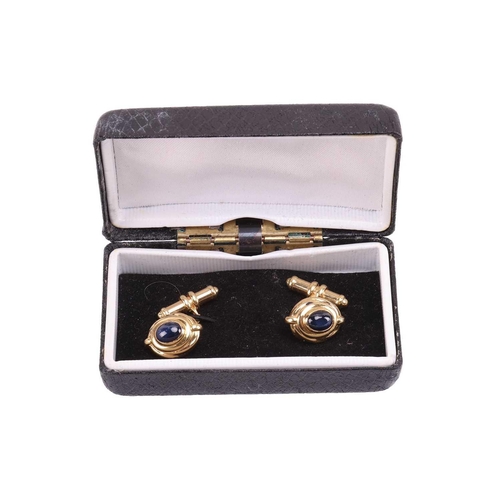 97 - A pair of sapphire-set cufflinks, of Hellenistic style, each contains an oval sapphire cabochon of 8... 