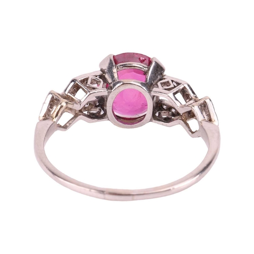 103 - An Edwardian ruby and diamond dress ring, centred with an oval-cut ruby of 8.0 x 7.2 x 3.2 mm, claw-... 