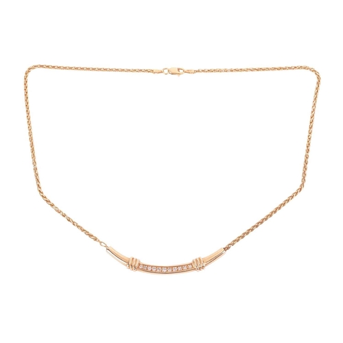 109 - A diamond-set necklace in 14ct yellow gold, comprising a curved pendant with ribbed motifs, pavé-set... 