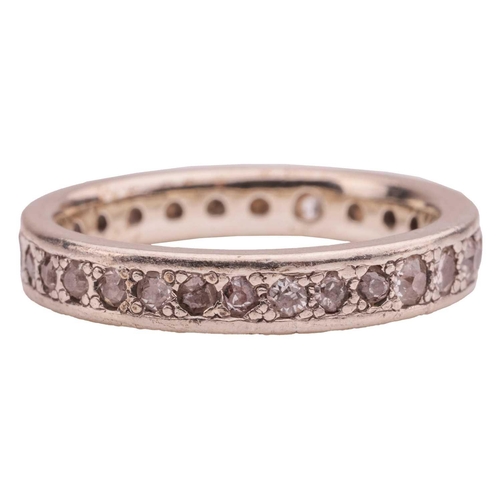 11 - A diamond-set eternity ring, gypsy-set with single-cut and round brilliant cut diamonds, in a white ... 