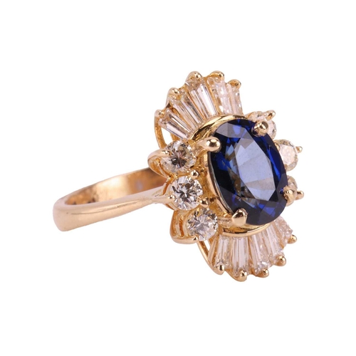 112 - A sapphire and diamond ballerina ring, centred with an oval-cut sapphire of 7.8 x 5.5 mm, claw-set w... 