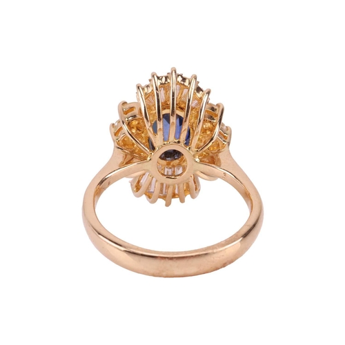 112 - A sapphire and diamond ballerina ring, centred with an oval-cut sapphire of 7.8 x 5.5 mm, claw-set w... 