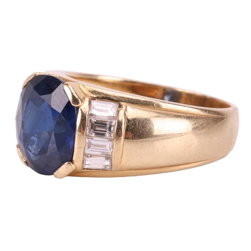 119 - A sapphire and diamond dress ring, consisting of an oval-cut sapphire of 10.2 x 8.8 x 5.4 mm, set be... 