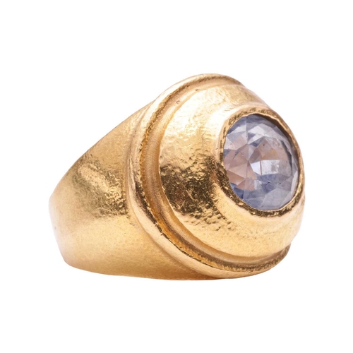 125 - A sapphire dress ring, centred with an oval-cut sapphire in pale purplish-blue, approximately measur... 