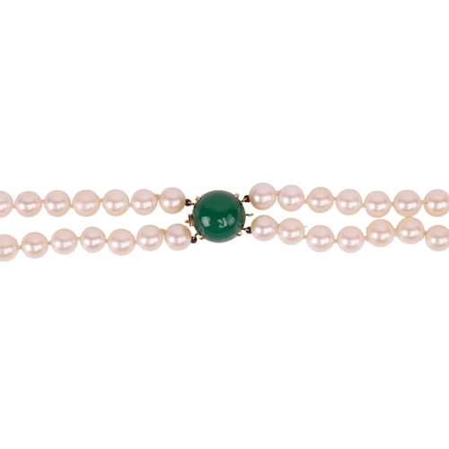 130 - A double-strand pearl necklace, the cultured pearls of cream body with pink overtones, measuring app... 