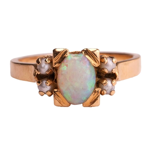 131 - An opal and seed pearl dress ring, featuring an opal cabochon measuring approximately 6.8mm x 5.2mm,... 