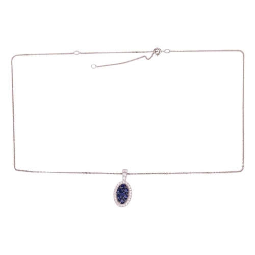 140 - A sapphire and diamond-set cluster pendant, the 18ct white gold oval mount featuring twelve round sa... 