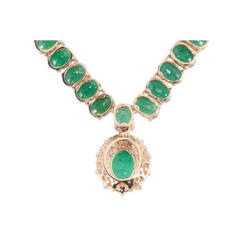 145 - An emerald and diamond necklace, composed of ninety six oval mixed-cut emeralds in a line of articul... 