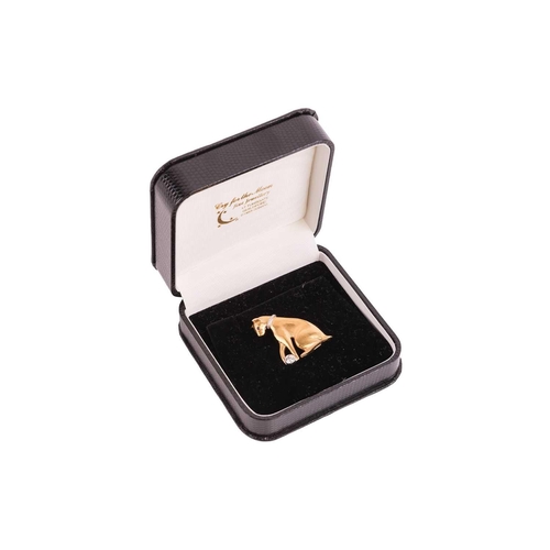 150 - A diamond-set cat brooch, set in 18ct gold, embossed in the form of a sitting cat playing with a bal... 