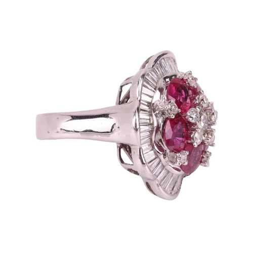 158 - A ruby and diamond ballerina ring the central brilliant-cut diamond cluster highlighted by six oval-... 