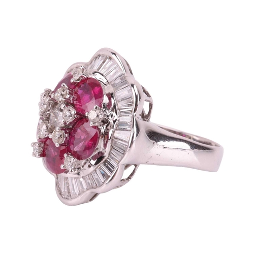 158 - A ruby and diamond ballerina ring the central brilliant-cut diamond cluster highlighted by six oval-... 