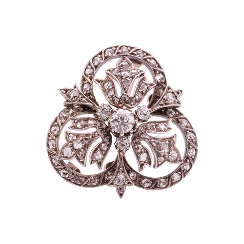 161 - An Edwardian diamond-set brooch, centred with an old-cut diamond cluster, encircled by foliate motif... 