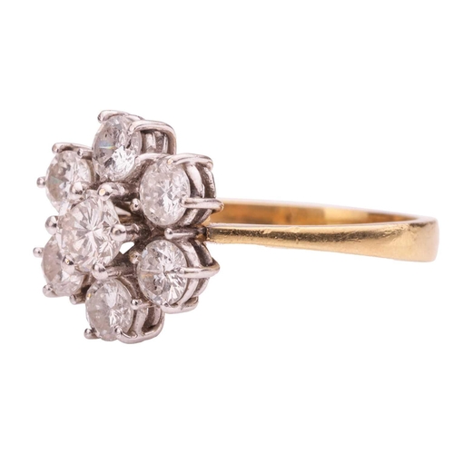 162 - A diamond-set floral cluster ring, claw-set with seven round brilliant diamonds, the central diamond... 