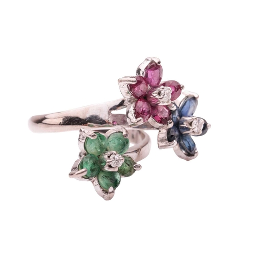 167 - A floral gem-set crossover ring, featuring three staggered flower heads, each set with a round brill... 