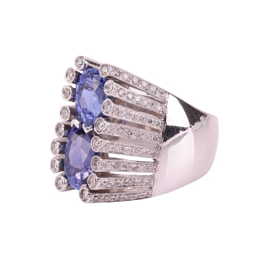 169 - A tanzanite and diamond cocktail ring, centrally claw-set with two pear-cut tanzanites, approximatel... 