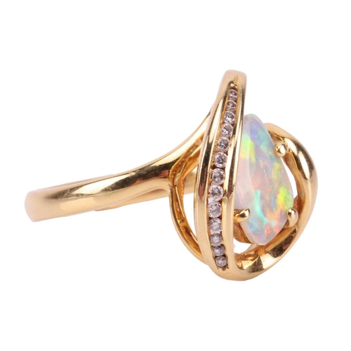 173 - An opal and diamond dress ring, featuring a free-form precious opal slice of 10.1 x 7.0 x 1.1 mm, di... 