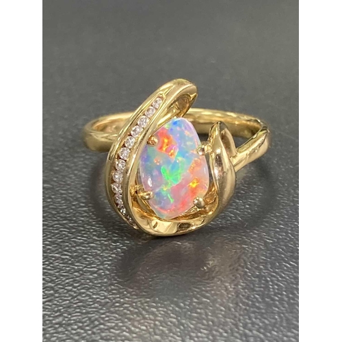 173 - An opal and diamond dress ring, featuring a free-form precious opal slice of 10.1 x 7.0 x 1.1 mm, di... 