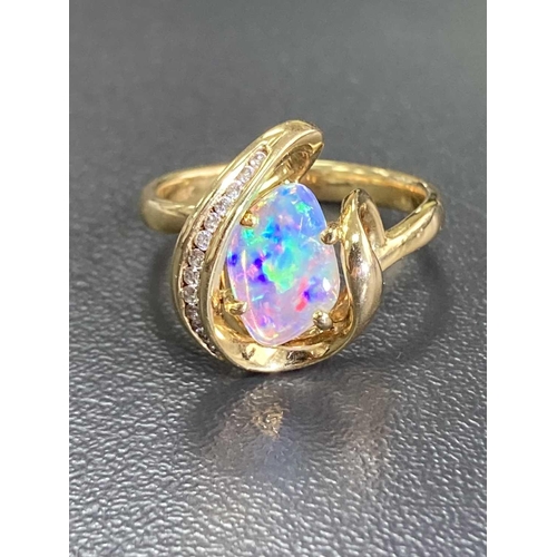 173 - An opal and diamond dress ring, featuring a free-form precious opal slice of 10.1 x 7.0 x 1.1 mm, di... 