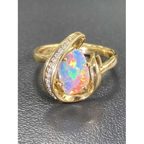 173 - An opal and diamond dress ring, featuring a free-form precious opal slice of 10.1 x 7.0 x 1.1 mm, di... 