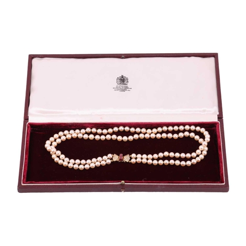 179 - A double-row cultured pearl necklace with a ruby and diamond clasp in 18ct gold, comprising two stra... 